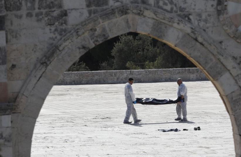 Israeli police remove assailant from Temple Mount compound (photo credit: AMMAR AWAD/REUTERS)