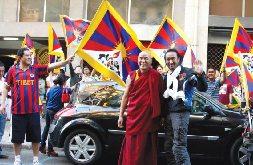 TIBETAN ACTIVIST Lhakpa Tsering poses with monk Thubten Wangchen upon arriving at the House of Tibet in Barcelona in 2010. (photo credit: REUTERS)