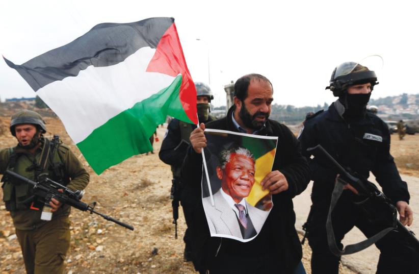 A CYCLE that feeds the apartheid analogy. (photo credit: REUTERS)