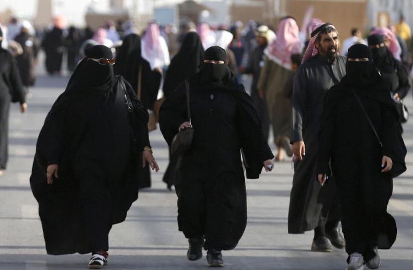 Women wearing traditional Saudi clothing, or an abaya (photo credit: REUTERS/FAISAL AL NASSER)