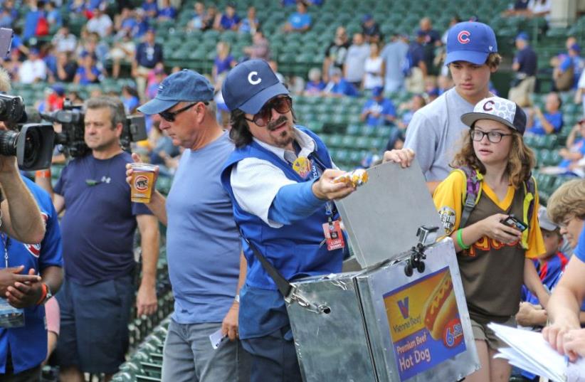 Sep 17, 2016; Chicago, IL, USA; Television personality Stephen Colbert is dressed as a hot dog vendor prior to a game between the Chicago Cubs and the Milwaukee Brewers at Wrigley Field (photo credit: REUTERS/DENNIS WIERZBICKI-USA TODAY SPORTS)