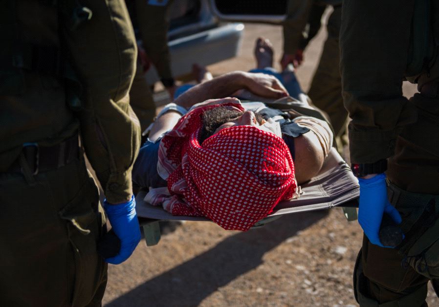 Israeli troops provide medical aid to a wounded Syrian (Credit: IDF)