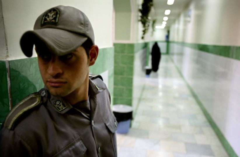 A prison guard stands along a corridor in Tehran's Evin prison June 13, 2006.  (photo credit: REUTERS)