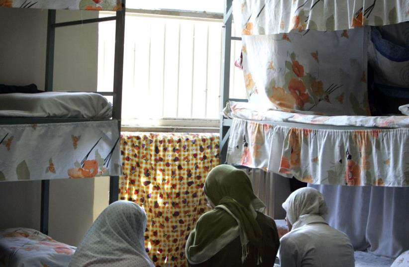 Iranian women prisoners sit at their cell in Tehran's Evin prison June 13, 2006.  (photo credit: REUTERS)