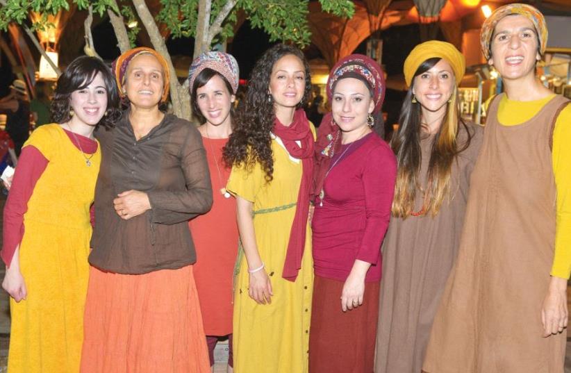 Spotlight artist Ana Elya (second from left), who sings as well as plays guitar and drums, with the Adamama choir (photo credit: JUDITH HARPAZ)