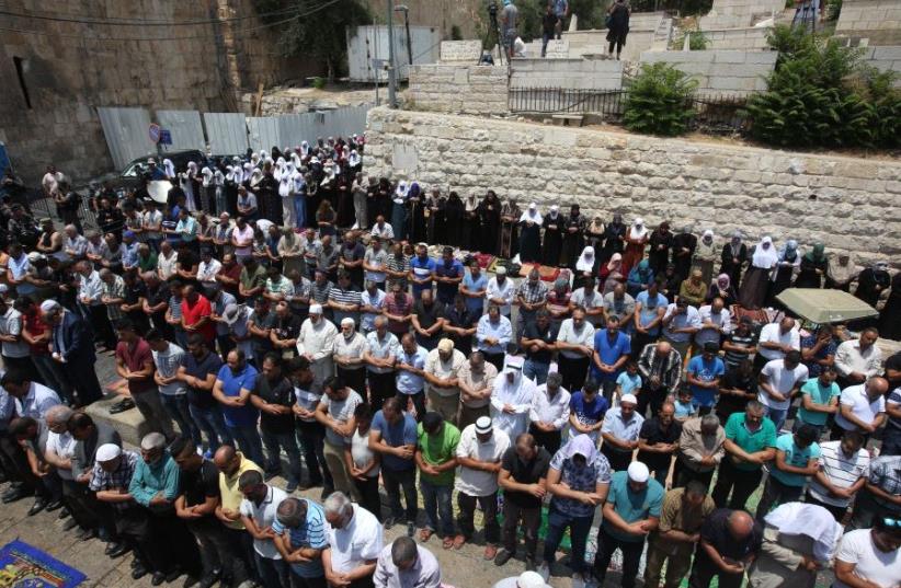An organized mass prayer session outside Jerusalem's Lions' Gate, July 2017 (photo credit: MARC ISRAEL SELLEM/THE JERUSALEM POST)