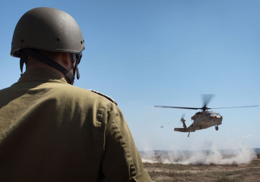A soldier watches a drill with a Blackhawk helicopter, July 2017/ IDF SPOKESPERSON'S UNIT 