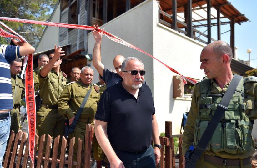 Defense Minister Avigdor Liberman and IDF Chief of Staff Gadi Eisenkot leave the scene of the deadly attack in Halamish, July 22, 2017. (photo credit: ARIEL HERMONI / DEFENSE MINISTRY)