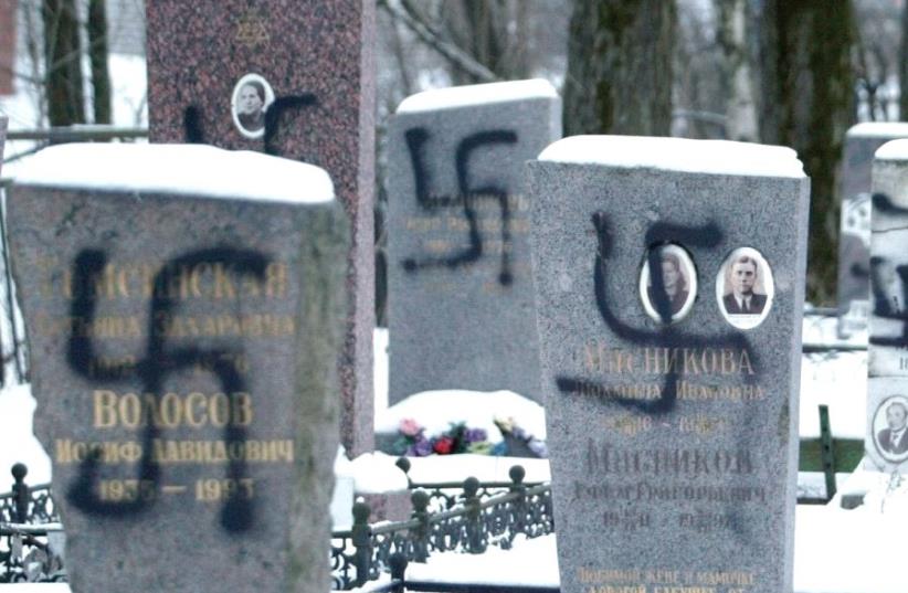 TOMBS DAUBED with Nazi swastikas are seen at a cemetery in St. Petersburg, Russia, in 2004. (photo credit: REUTERS)