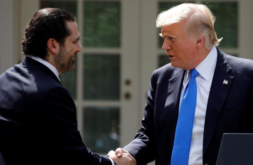 US President Donald Trump shakes hands with Lebanese Prime Minister Saad al-Hariri during a press conference in the Rose Garden of the White House in Washington, US, July 25, 2017. (photo credit: REUTERS)