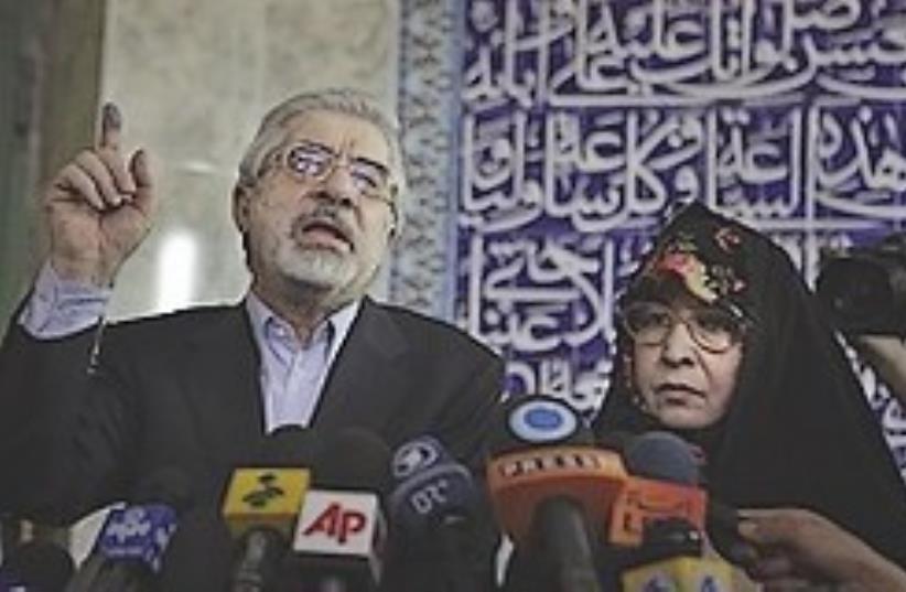 Mousavi speaks to the media with his wife Zahra Ra (photo credit: AP)