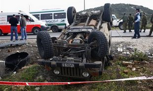 An over turned IDF jeep is seen after a stabbing attack in the West Bank junction of Tapuah, near Nablus Wednesday. (AP)