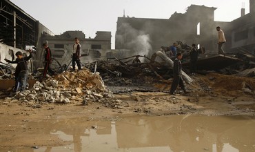 Palestinians pass rubble from IAF strike, Gaza