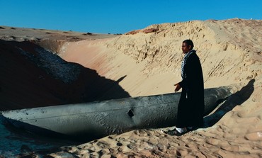 BEDUIN man looks at a gas pipeline in Sinai - Photo: REUTERS