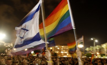 Pride flags being waved next to Israeli flags 