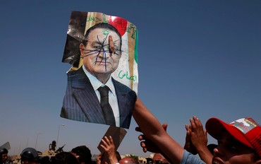 Anti-Mubarak protesters holds defaced picture