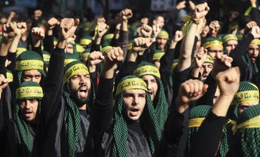 Lebanon's Hezbollah supporters gesture as they march in Beirut, November 2011