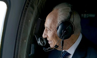 President Peres looking at field drawing of himself from airplane made for his 90th birthday