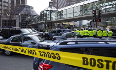 Boston Police coordinate the scene after two blasts at the Boston Marathon, April 15, 2013. 