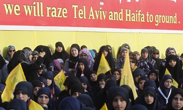 Women are seen watching Nasrallah at an event marking Resistance and Liberation Day, May 25, 2013.