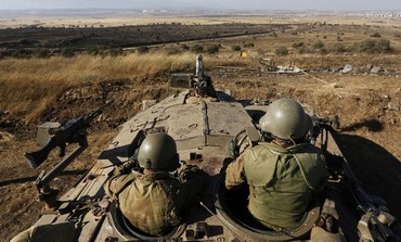 IDF troops survey the Golan Heights.