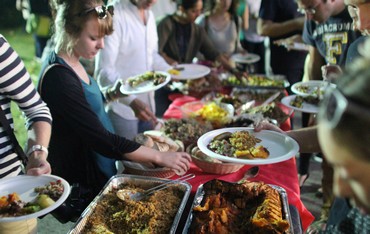 Guests serve themselves at a buffet table piled with food prepared by US chefs (Tracy Levy)