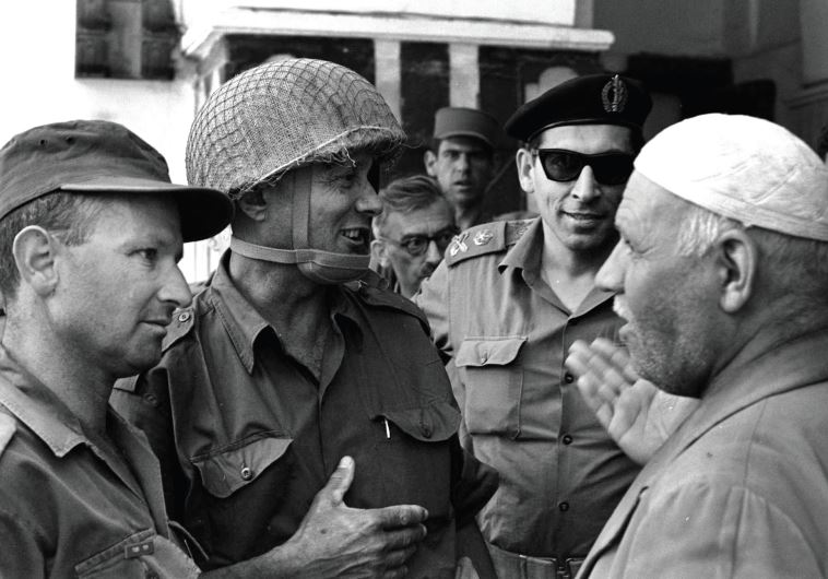 Former defense minister Moshe Dayan, (center), and Gen. Rehavam Ze'evi, (2nd left), in conversation with the Palestinian keeper of the Cave of the Patriarchs in Hebron during the Six Day War (photo credit: AFP PHOTO)