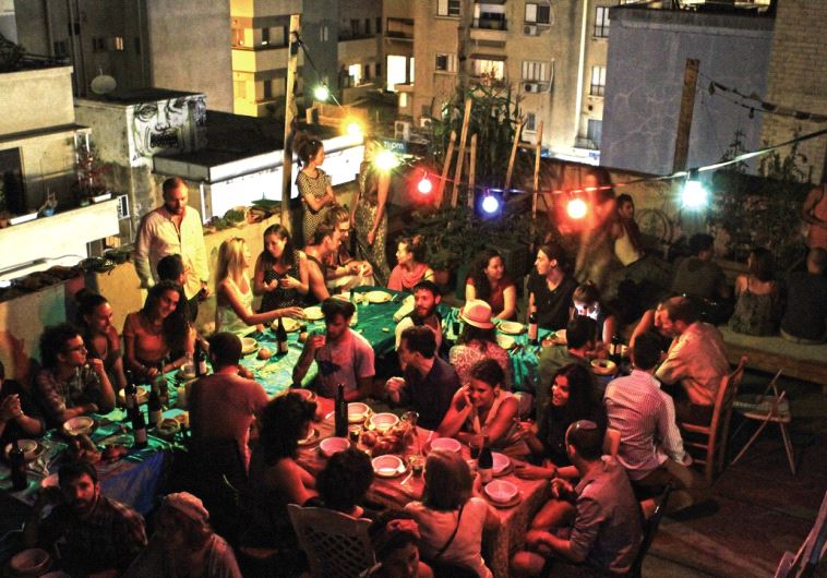 Shabbat dinner on the roof in Tel Aviv, following a seaside Kabbalat Shabbat event on Frishman Beach in the summer of 2014 (photo credit: ZAN MOSTOW)