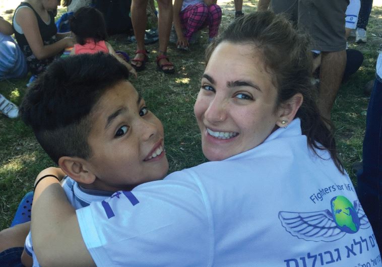 A FFL volunteer drapes her arm around a young Argentinian boy