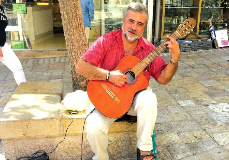 Classical guitarist Michael Sud (left) plays on Ben-Yehuda Street (photo credit: ARIEL HENDELMAN)