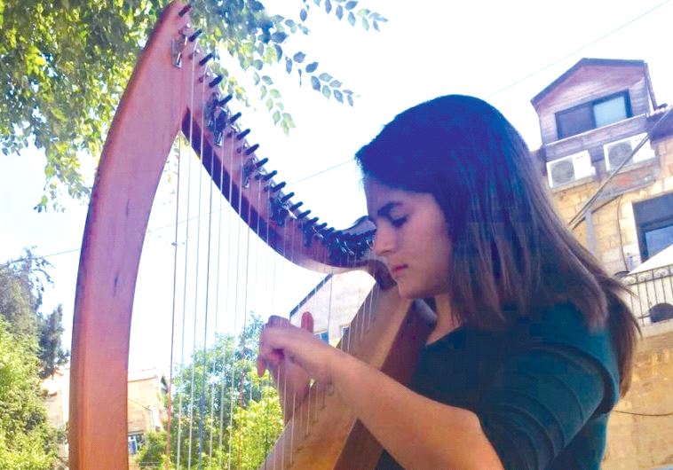 Sara Katsof plucks her harp in Nahlaot .(photo credit: AVIVA ROZMARYN)