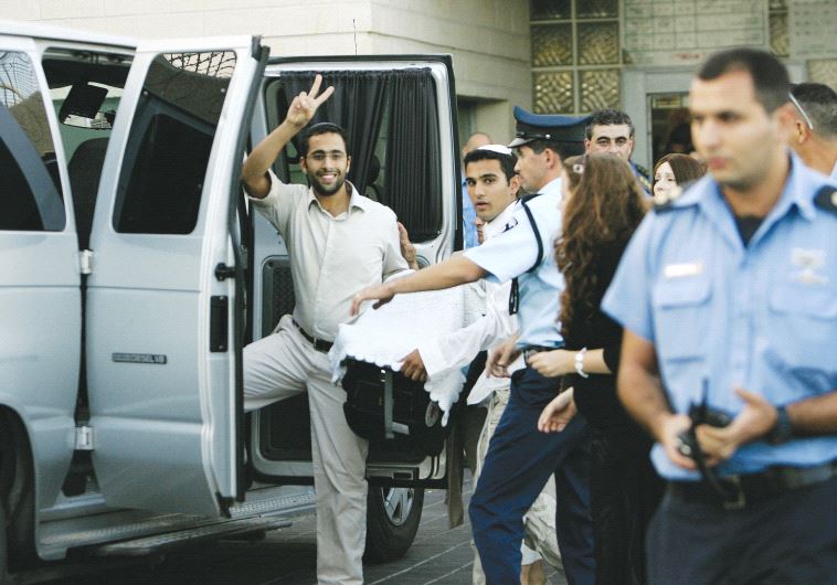 The newborn baby of Yigal Amir is carried as a family member gestures following his circumcision at Rimonim prison on November 4, 2007 (photo credit: REUTERS)