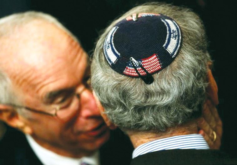 An American Jew wearing a kippa embroidered with the US and Israeli flags attends a Hanukka reception at the White House last year (photo credit: REUTERS)