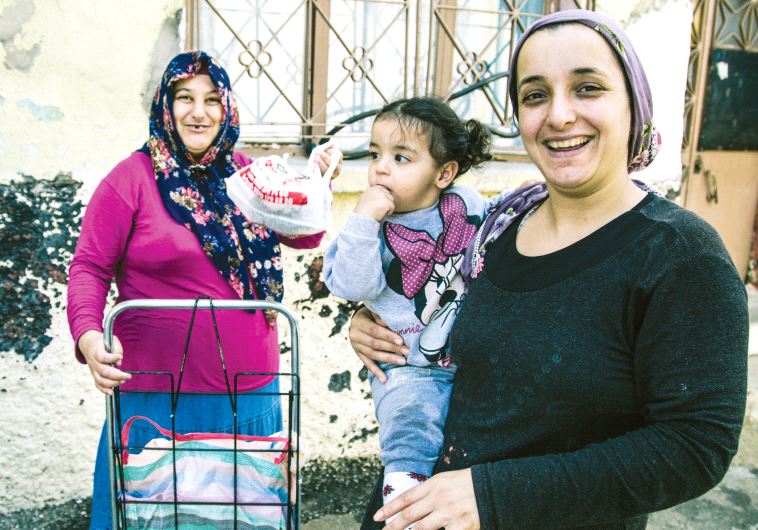 A family of Kurds from Mardin, southeastern Turkey, in front of their house in the neighborhood (photo credit: GIACOMO SINI)
