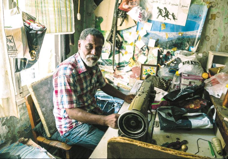 A textile worker who organizes supplies for refugees living in the neighborhood (photo credit: GIACOMO SINI)