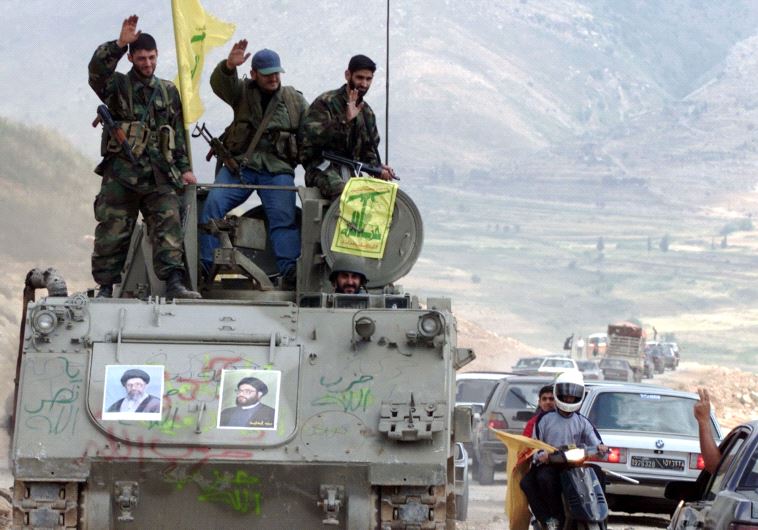 Pro-Iranian Hezbollah guerrillas, riding on an APC M113 in southern Lebanon (Reuters)