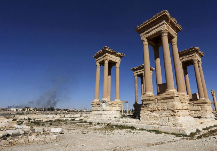 Smoke rises from the modern city as seen from the historic city of Palmyra, in Homs Governorate, Syria in this April 1, 2016 (Reuters)