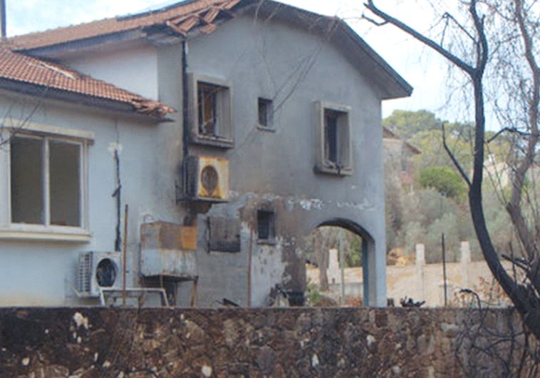 A badly damaged house in Zichron Ya’acov stands in its burned-out garden (photo credit: MOED COMMUNITY AND EDUCATION CENTER)