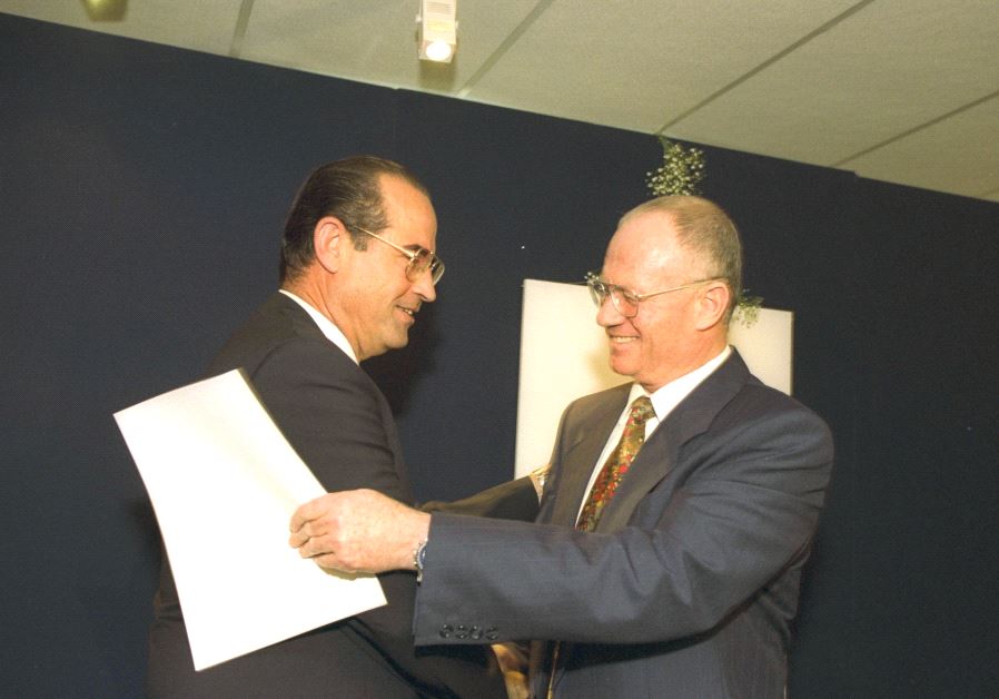 Outgoing Mossad head Shabtai Shavit (left) hugging his successor, Danny Yatom, during the change of command ceremony in the Prime Minister’s Office in June 1996 (photo credit: SA’AR YA’ACOV/GPO)
