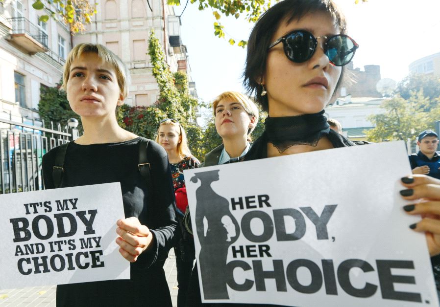 Women holding "It's my body and it's my choice" signs during a protest (photo credit: ILLUSTRATIVE: REUTERS)