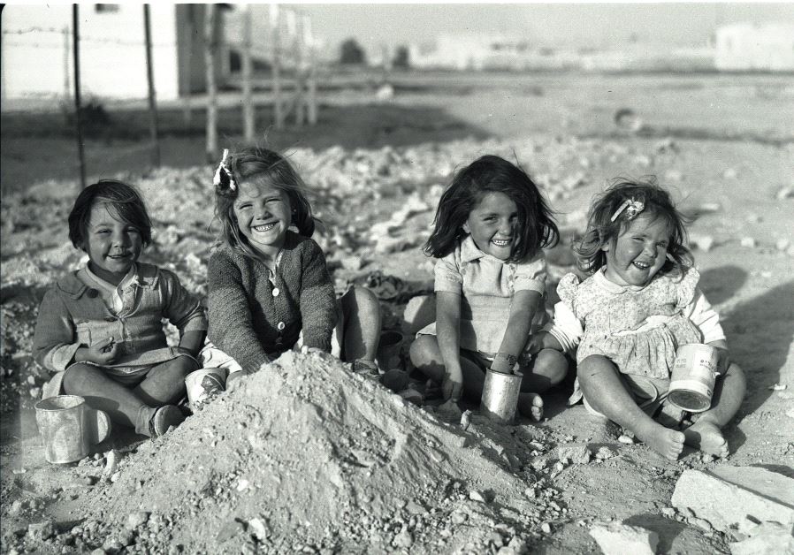 Children, recent immigrants, playing outside a new housing cooperative in Beersheba, 1950 (photo credit: BENO ROTHENBERG)