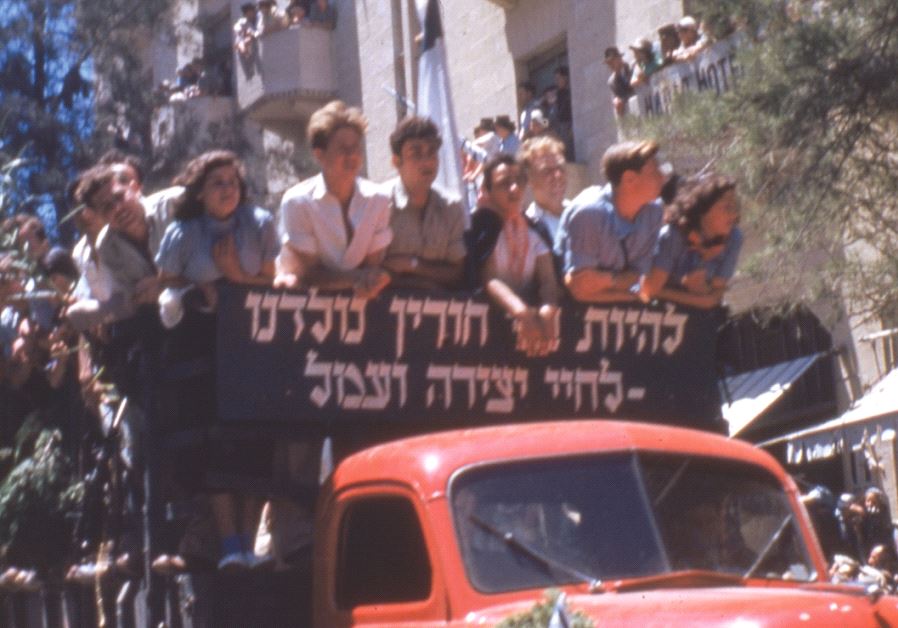 ‘We were born to be free – for a life of creativity and labor’ reads a sign on a truck bearing youth celebrating Israel’s first Independence Day in Jerusalem, May 1949 (photo credit: MOSHE MARLIN LEVIN)