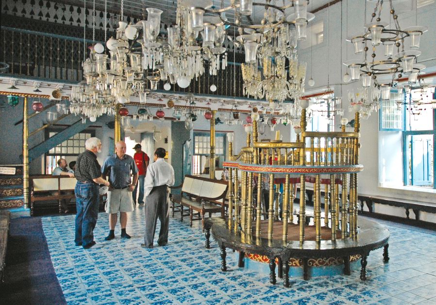 Kochi's Paradesi Synagogue features grand chandeliers and hand-painted, blue willow-patterned ceramic floor tiles. (photo credit: WOUTER HAGENS/WIKIMEDIA)