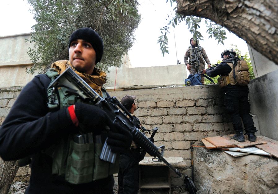 ISOF troops conduct a search of a house near the university, January 15 (photo credit: REUTERS)