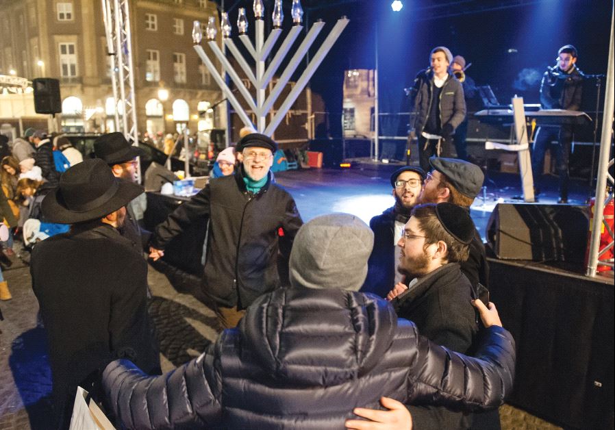 The threats facing Dutch Jews have not prevented some from celebrating holidays in public spaces, such as this 2016 Hanukka gathering in Amsterdam (photo credit: ROMY ARROYO FERNANDEZ / NURPHOTO)