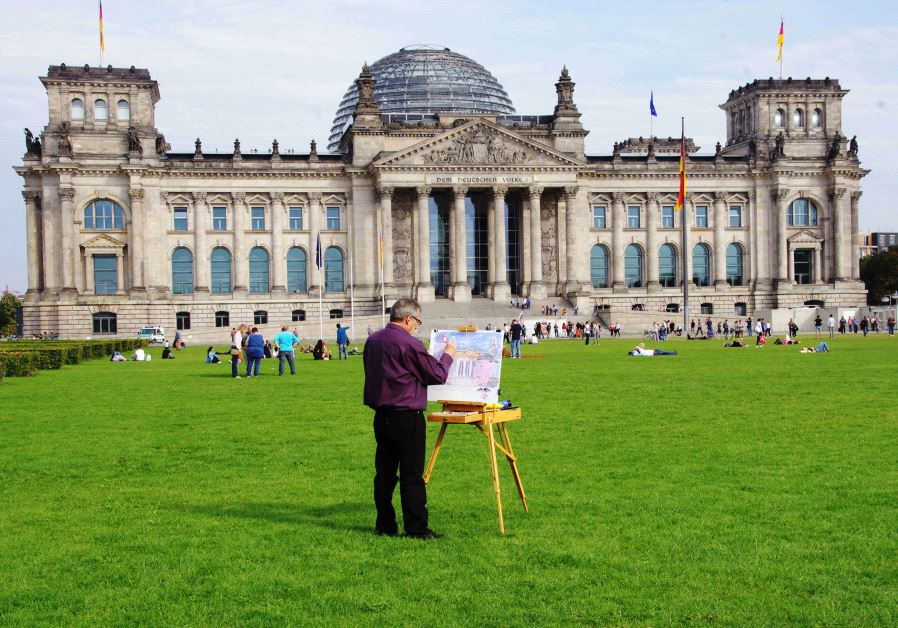 Philippe Mora painting at the Reichstag in Berlin, Germany (credit: COURTESY)