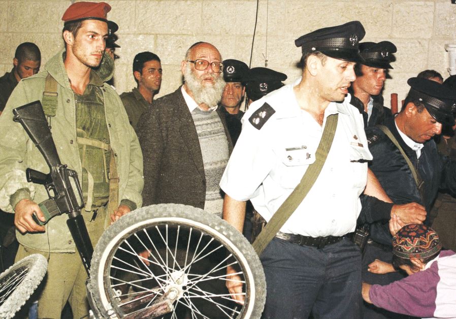 Israeli police arrest Rabbi Moshe Levinger (center) for inciting violence against the government, 1984 (REUTERS) 