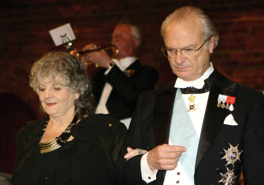 KING CARL XVI Gustaf of Sweden walks down the stairs with Ada Yonath, the 2009 Nobel Prize winner in Chemistry (and who won an EMET Prize in 2006), as they arrive for the Nobel Banquet in Stockholm that year.