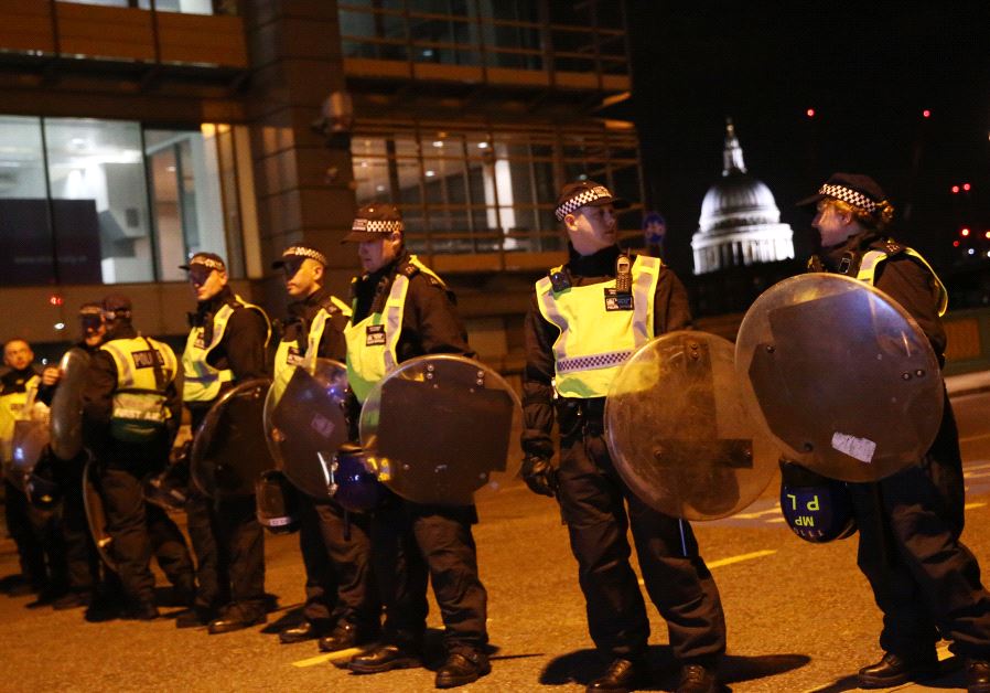Police officers guard the approach to Southwark Bridge (credit: REUTERS/Neil Hall)