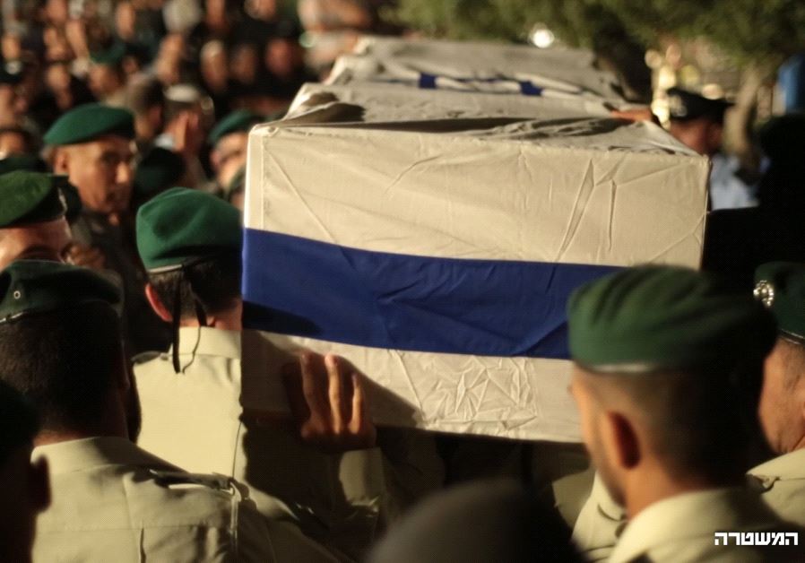 Officers carry Malka’s casket at an Ashdod cemetery Saturday night. (POLICE SPOKESPERSON'S UNIT) 